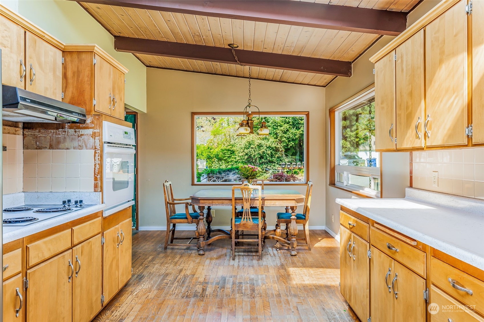 1213 North 33rd Street Renton, WA 98056 - Photo 9 of 28 a kitchen with stainless steel appliances granite countertop a stove and a wooden floors