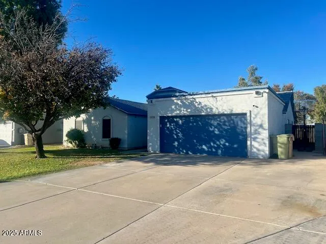 a view of a house with a yard and garage