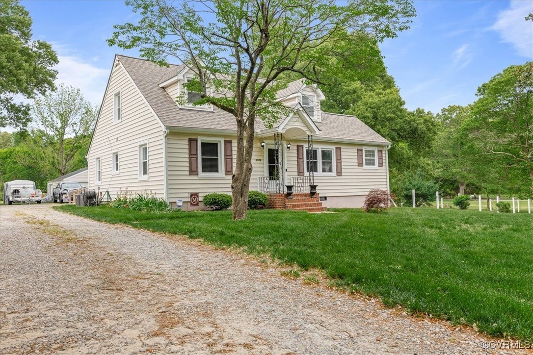 a front view of house with yard and green space
