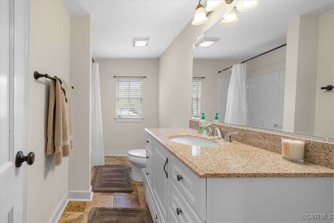 1926 Point Of Rocks Road Chester, VA 23836 - Photo 18 of 29 a bathroom with a granite countertop sink a mirror and a shower