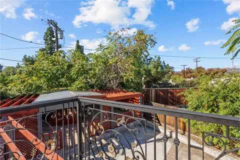 an empty room with a window and a kitchen