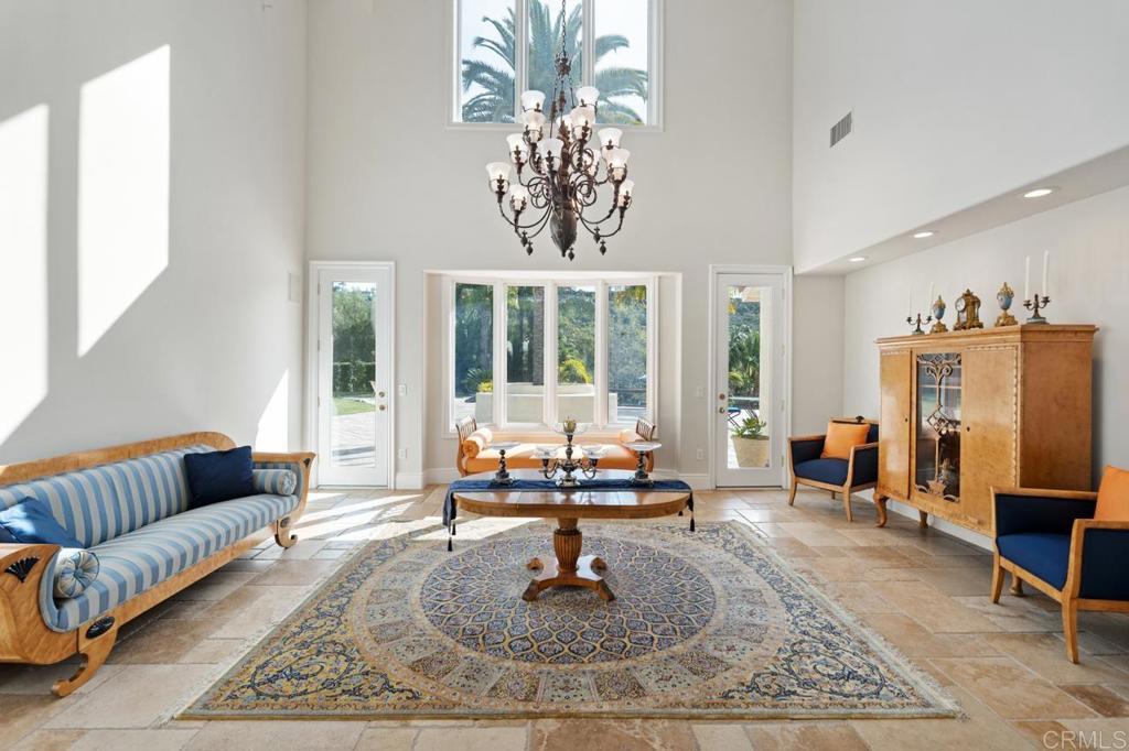 6773 Poco Lago Rancho Santa Fe, CA 92067 - Photo 14 of 65 a living room with furniture and a chandelier