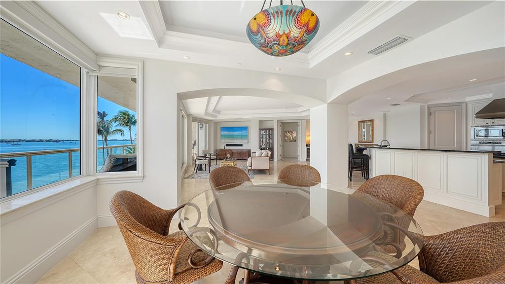 464 Golden Gate Point, Unit 304 Sarasota, FL 34236 - Photo 11 of 60 a dining room with furniture a table and chairs