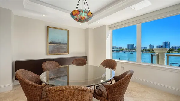 a dining room with furniture and a large window