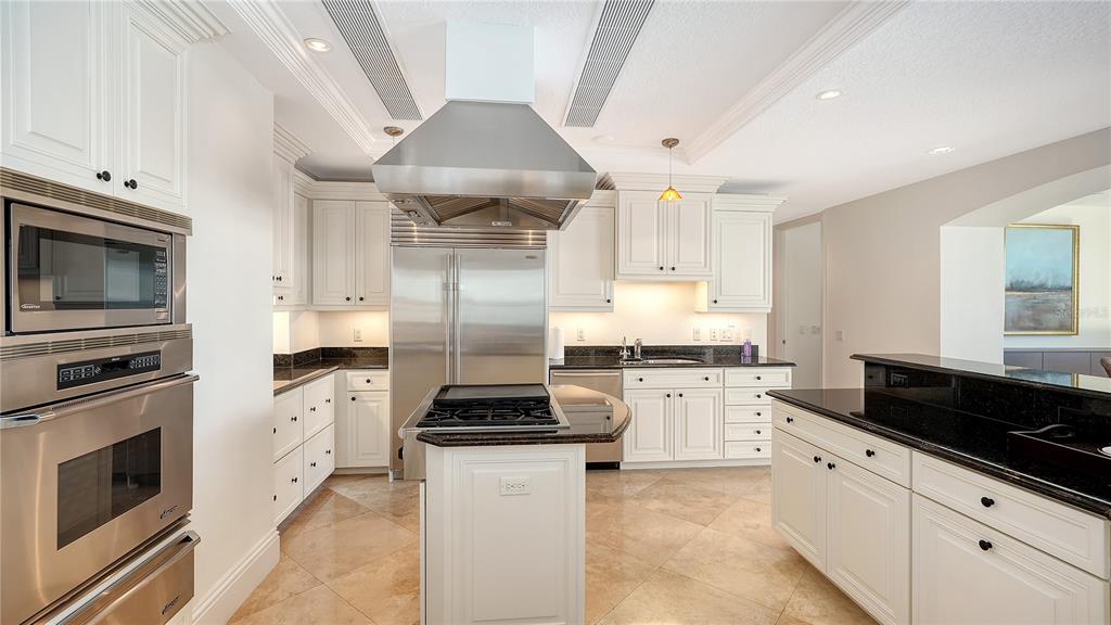464 Golden Gate Point, Unit 304 Sarasota, FL 34236 - Photo 15 of 60 a kitchen with stainless steel appliances a stove a sink and a refrigerator