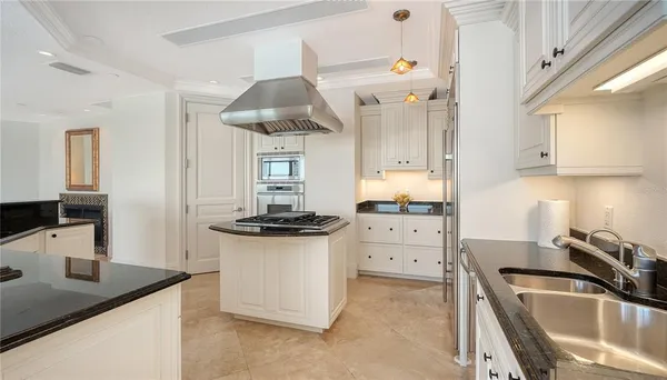 a kitchen with a sink a stove and cabinets