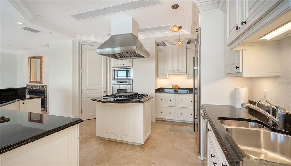 464 Golden Gate Point, Unit 304 Sarasota, FL 34236 - Photo 16 of 60 a kitchen with a sink a stove and cabinets