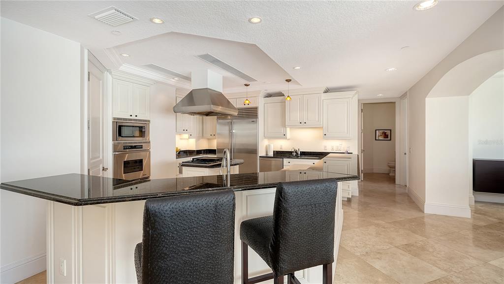 464 Golden Gate Point, Unit 304 Sarasota, FL 34236 - Photo 17 of 60 a kitchen with stainless steel appliances granite countertop a stove refrigerator and a sink