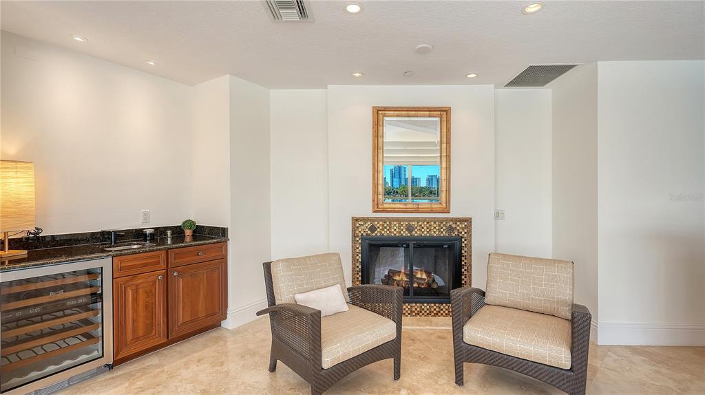 464 Golden Gate Point, Unit 304 Sarasota, FL 34236 - Photo 18 of 60 a living room with furniture a window and a fireplace