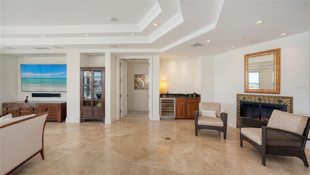 464 Golden Gate Point, Unit 304 Sarasota, FL 34236 - Photo 19 of 60 a living room with furniture and a fireplace