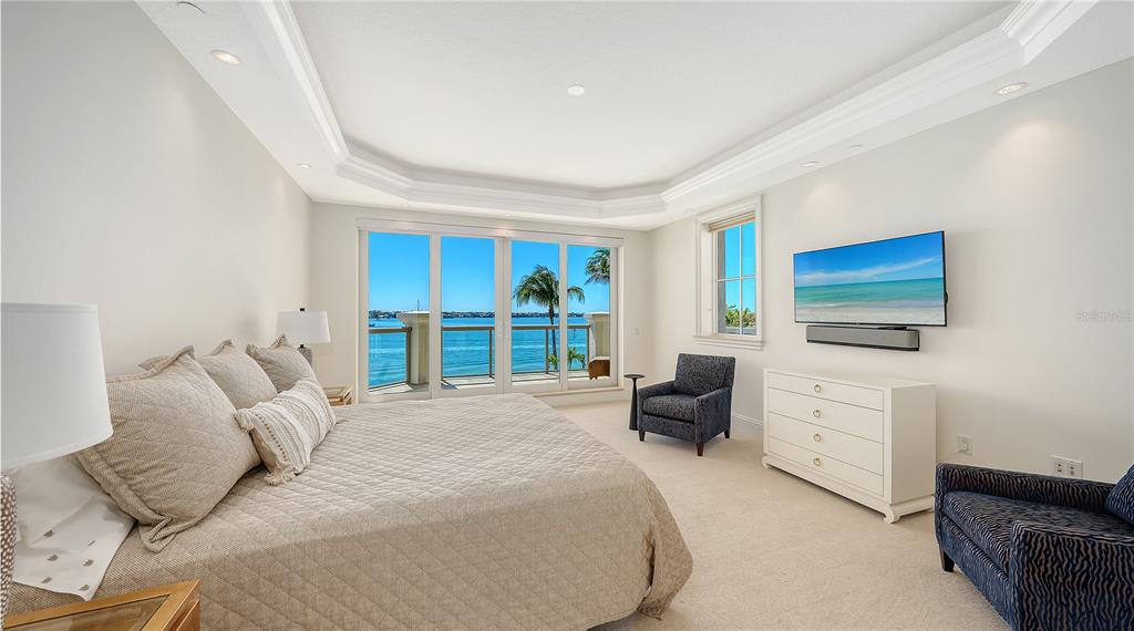 464 Golden Gate Point, Unit 304 Sarasota, FL 34236 - Photo 24 of 60 a bedroom with a bed and a flat screen tv