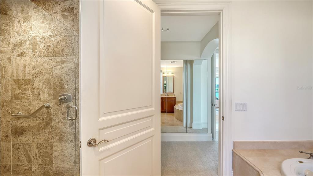 464 Golden Gate Point, Unit 304 Sarasota, FL 34236 - Photo 27 of 60 a view of a bathroom from a hallway
