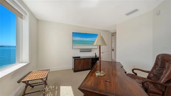 a bedroom with a bed and a lamp