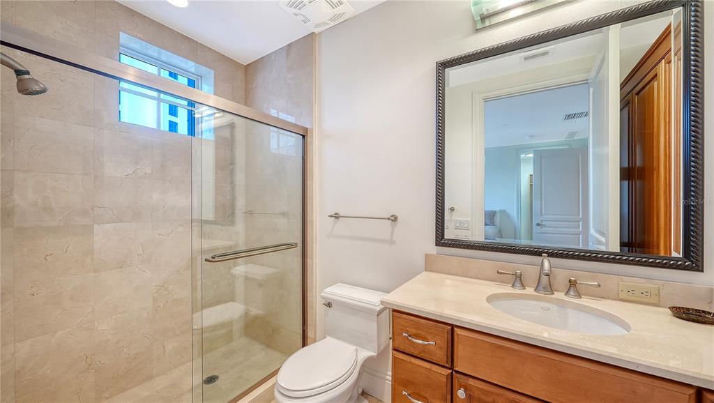 464 Golden Gate Point, Unit 304 Sarasota, FL 34236 - Photo 33 of 60 a bathroom with a sink a toilet and shower
