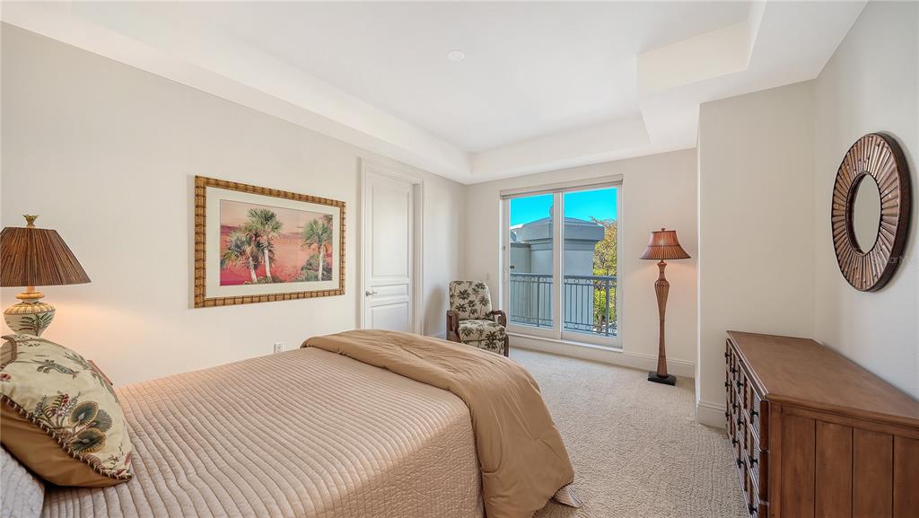 464 Golden Gate Point, Unit 304 Sarasota, FL 34236 - Photo 34 of 60 a bedroom with a bed a couch and a window