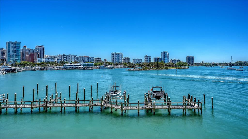 464 Golden Gate Point, Unit 304 Sarasota, FL 34236 - Photo 46 of 60 a view of a lake with a table and chairs