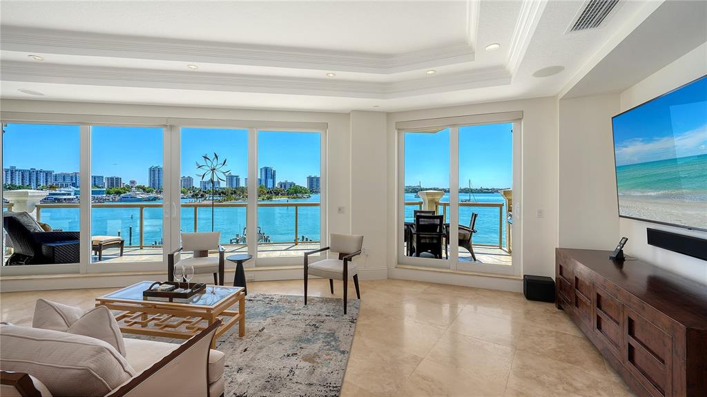 464 Golden Gate Point, Unit 304 Sarasota, FL 34236 - Photo 6 of 60 a living room with furniture and a floor to ceiling window