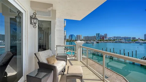 a view of balcony with furniture and city view