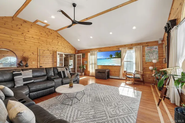 a living room with furniture ceiling fan and a rug