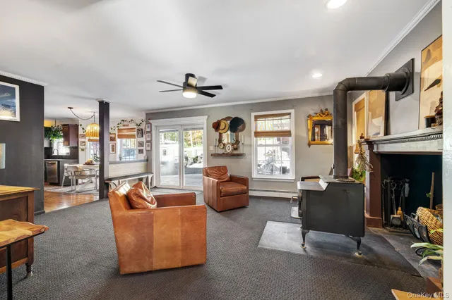 a living room with fireplace furniture and a window