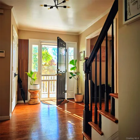 a view of an entryway with wooden floor and door