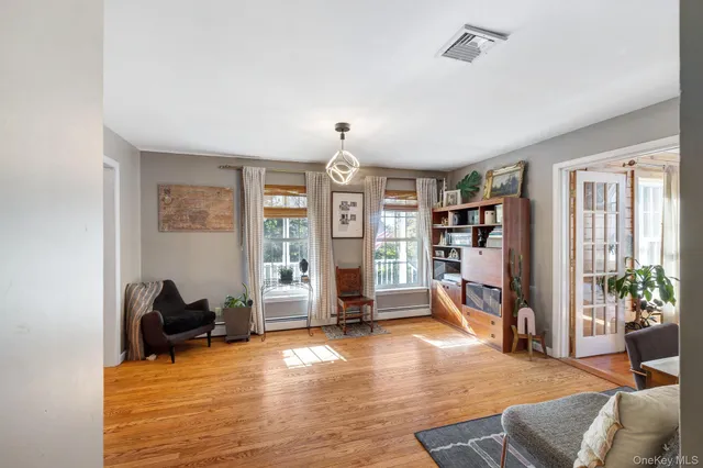 a living room with furniture gym equipment and a large window