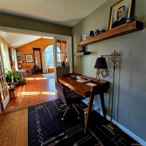 a view of a workspace with furniture and a potted plant