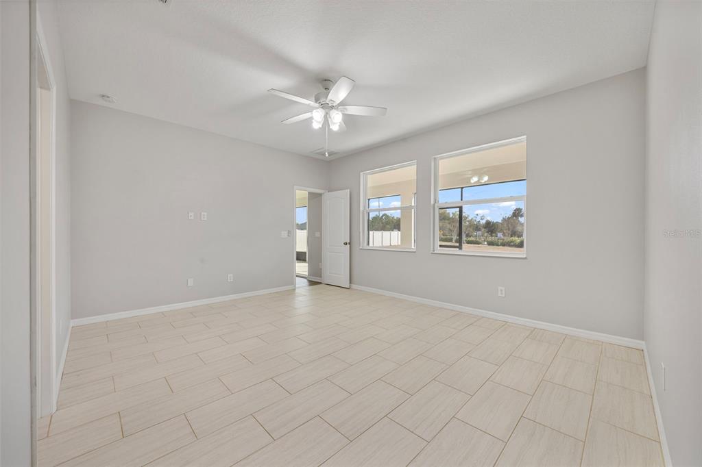 5356 Ragusa Loop St. Cloud, FL 34771 - Photo 39 of 69 an empty room with windows and fan