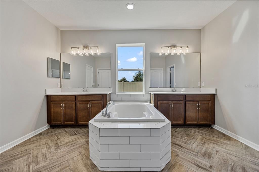 5356 Ragusa Loop St. Cloud, FL 34771 - Photo 40 of 69 a bathroom with a sink and a mirror