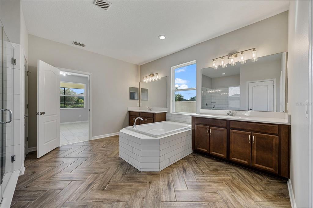 5356 Ragusa Loop St. Cloud, FL 34771 - Photo 42 of 69 a spacious bathroom with a tub sink and mirror