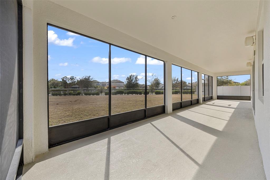 5356 Ragusa Loop St. Cloud, FL 34771 - Photo 49 of 69 a view of an empty room with a floor to ceiling window and a city view