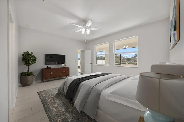 a living room with furniture a flat screen tv and a window