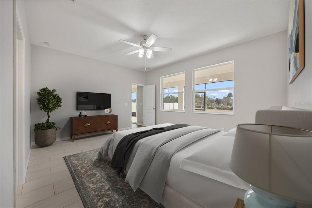 5356 Ragusa Loop St. Cloud, FL 34771 - Photo 6 of 69 a living room with furniture a flat screen tv and a window