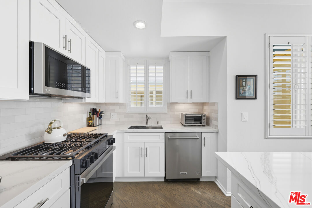 13200 Pacific Promenade, Unit 409 Playa Vista, CA 90094 - Photo 1 of 1 a kitchen with stainless steel appliances granite countertop a stove a sink and a microwave