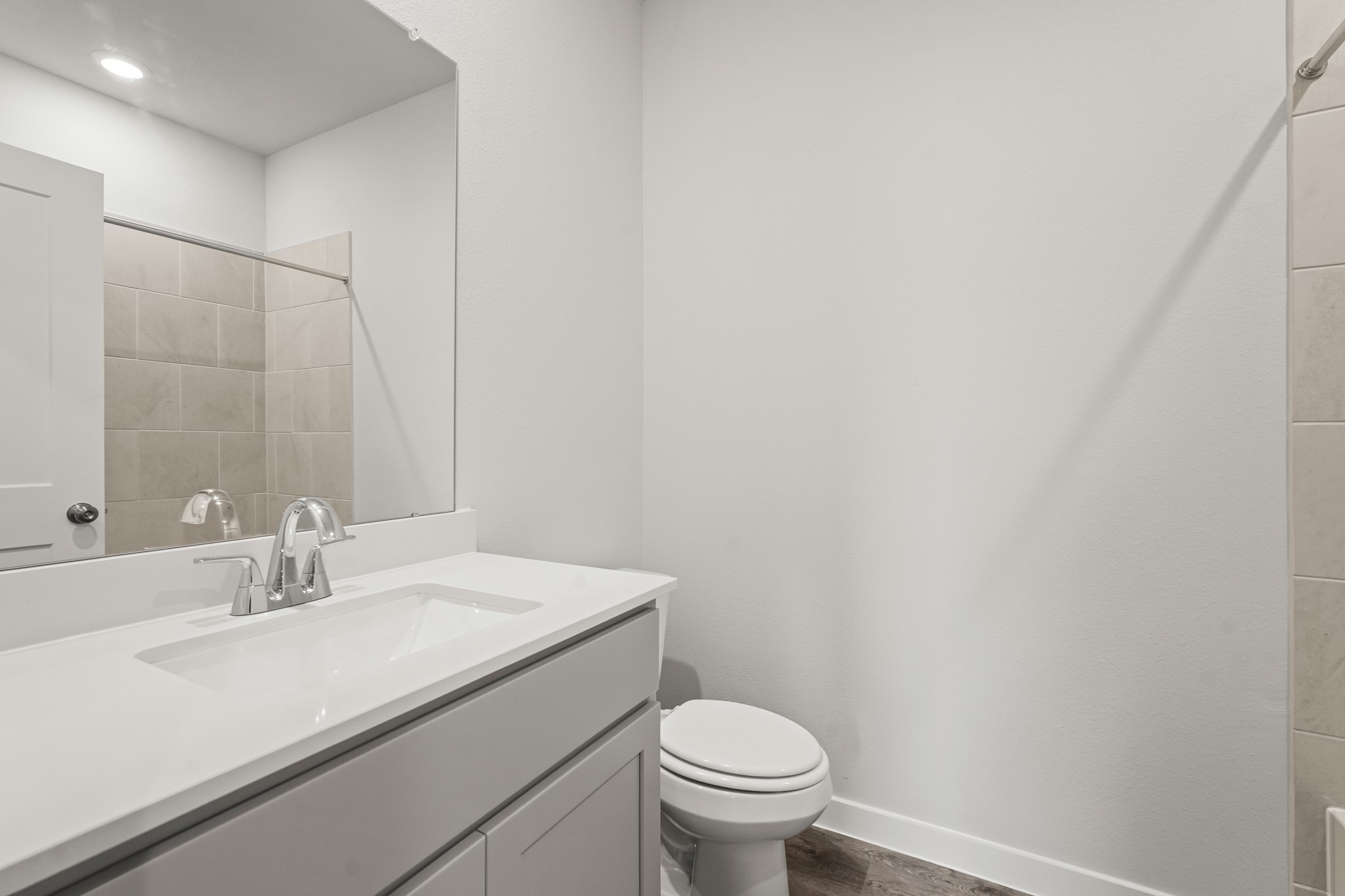 213 Spring Drive Hockley, TX 77447 - Photo 8 of 26 a bathroom with a sink a toilet and a mirror