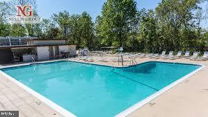 4600 Duke Street, Unit 507 Alexandria, VA 22304 - Photo 16 of 16 a view of a swimming pool with a patio and a yard
