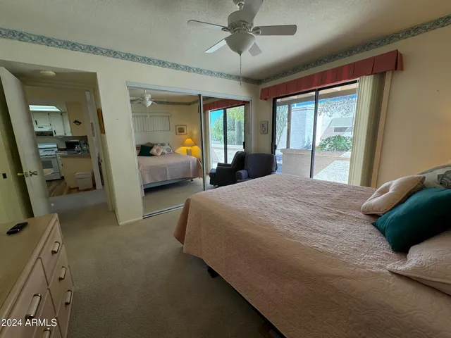 a bedroom with a large bed and a large window