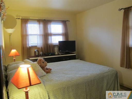 770 Magnolia Road North Brunswick, NJ 08902 - Photo 11 of 25 a bedroom with a bed and a chandelier