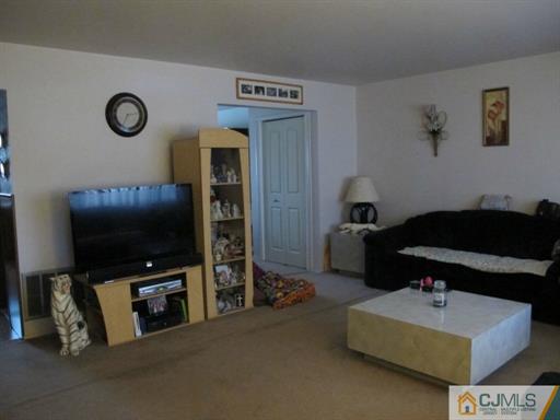 770 Magnolia Road North Brunswick, NJ 08902 - Photo 14 of 25 a living room with furniture and a flat screen tv