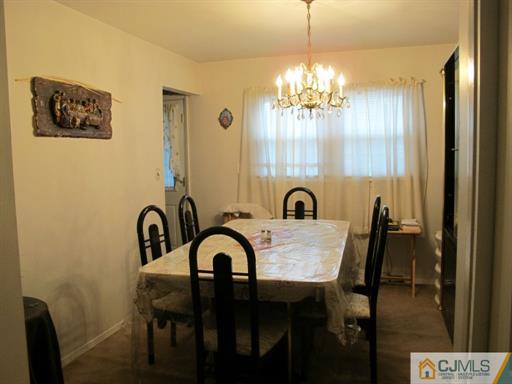 770 Magnolia Road North Brunswick, NJ 08902 - Photo 15 of 25 a view of a dining room with furniture and chandelier