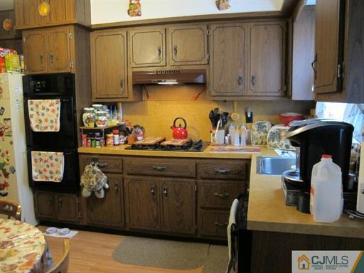 770 Magnolia Road North Brunswick, NJ 08902 - Photo 16 of 25 a kitchen with stainless steel appliances granite countertop a refrigerator sink and cabinets