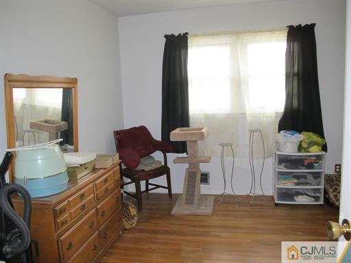 770 Magnolia Road North Brunswick, NJ 08902 - Photo 20 of 25 a living room with furniture and a flat screen tv