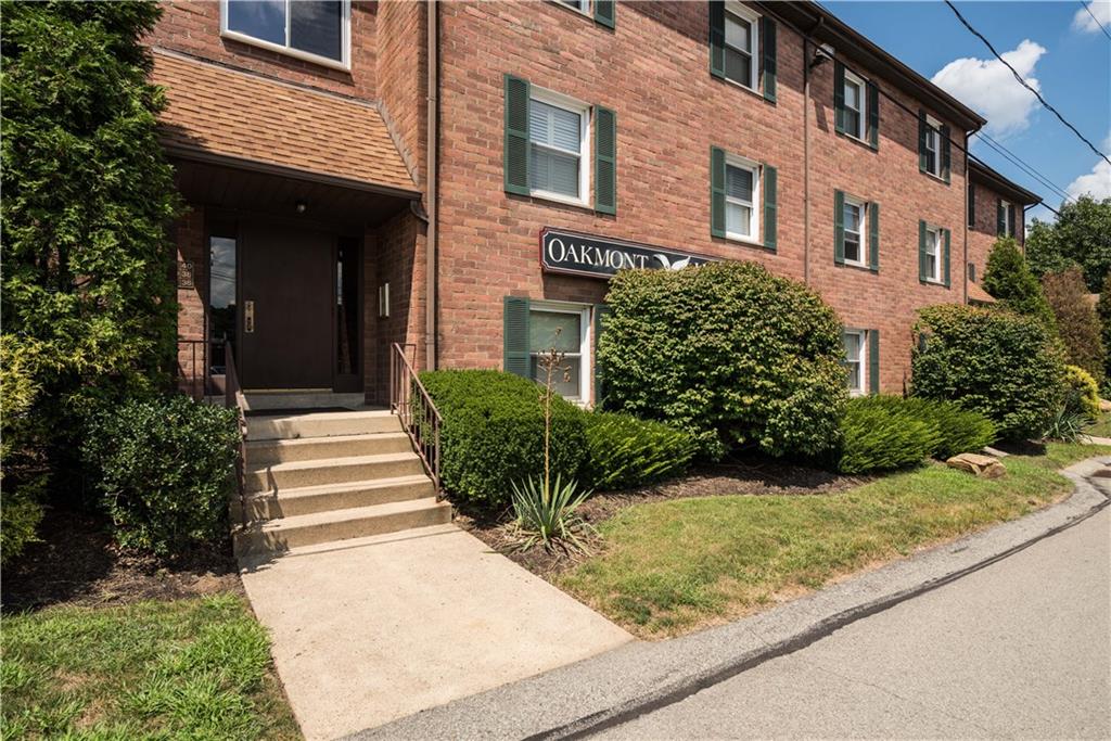 41 Huston Road, Unit 41 Oakmont, PA 15139 - Photo 1 of 15 a view of a house with potted plants and large trees