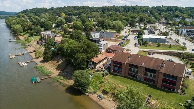 an aerial view of multiple houses with yard