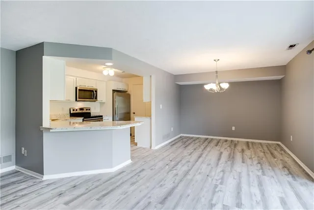 a view of a kitchen with wooden floor and a sink