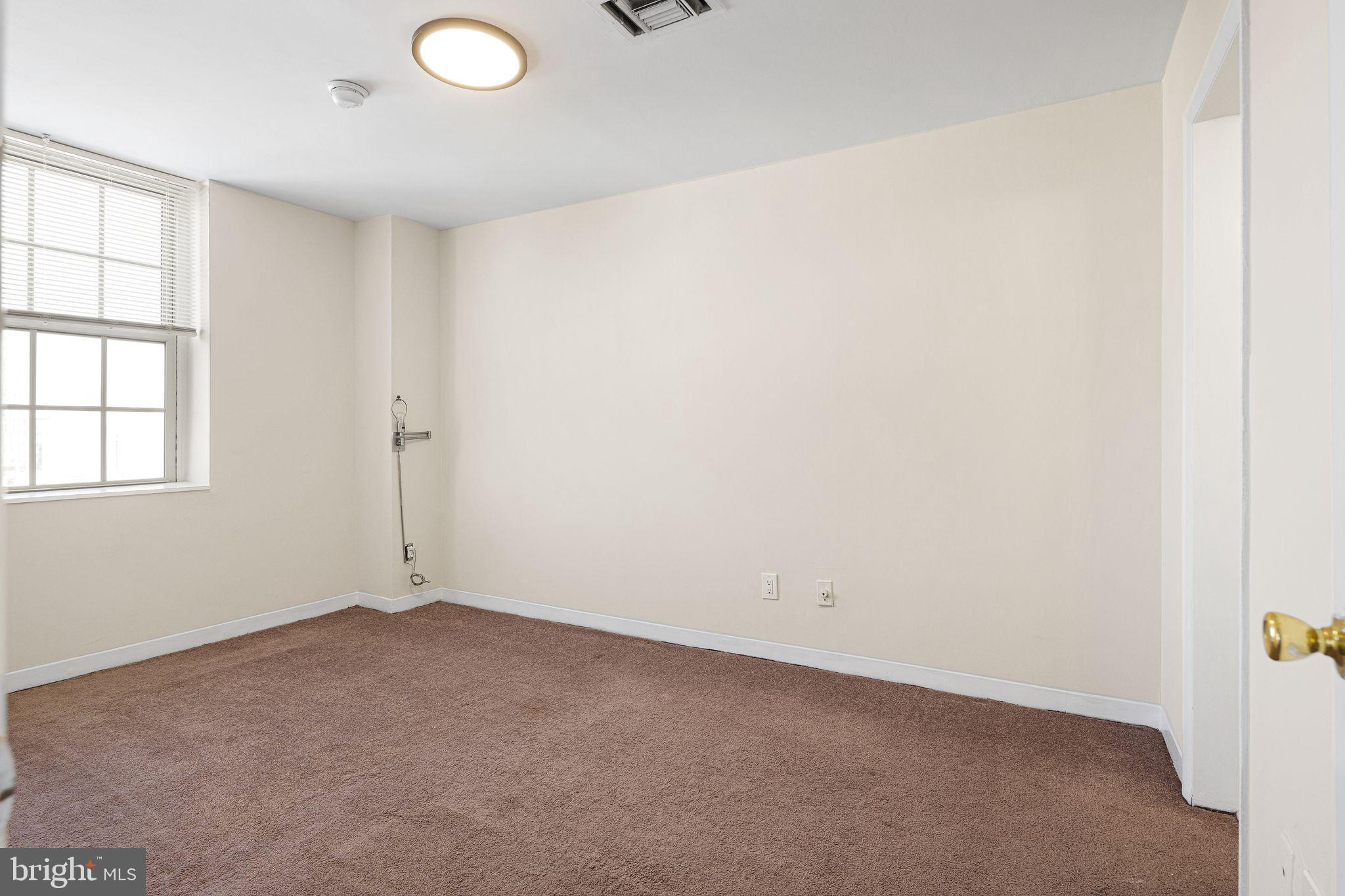 2135 Walnut Street, Unit 1103 Philadelphia, PA 19103 - Photo 11 of 18 an empty room with windows