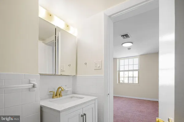 a bathroom with a sink and a window