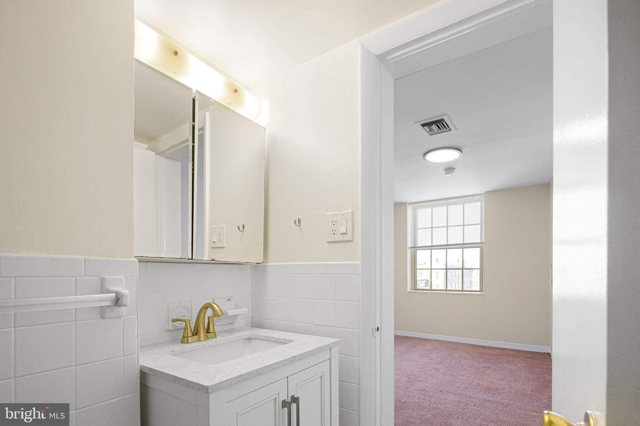 2135 Walnut Street, Unit 1103 Philadelphia, PA 19103 - Photo 14 of 18 a bathroom with a sink and a window