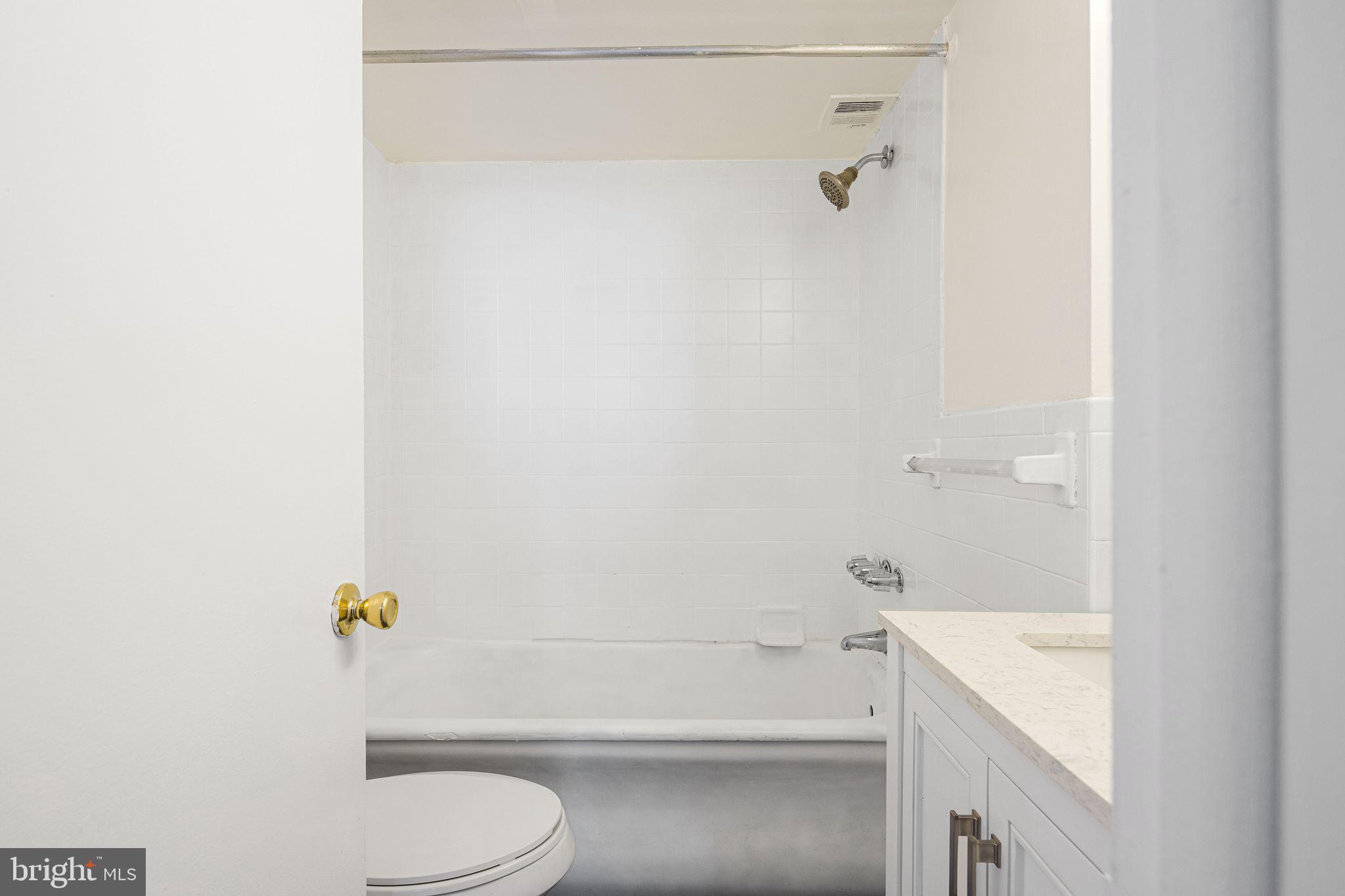 2135 Walnut Street, Unit 1103 Philadelphia, PA 19103 - Photo 16 of 18 a bathroom with a sink a toilet and shower