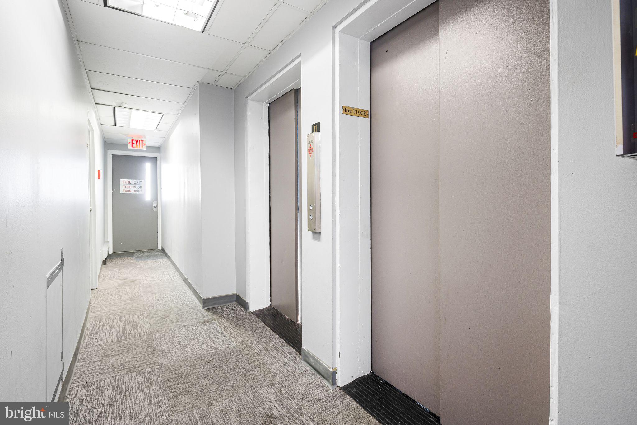2135 Walnut Street, Unit 1103 Philadelphia, PA 19103 - Photo 3 of 18 a view of a hallway with wooden floor and a bathroom